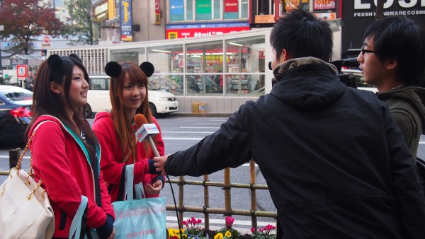 Two girls interviewed at Shibuya, Tokyo, Japan