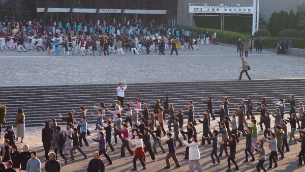 Groups of people practising taichi in front of Yoyogi Stadium at Harajuku, Tokyo, Japan