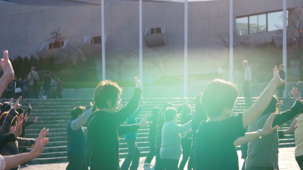 Groups of people practising taichi in front of Yoyogi Stadium at Harajuku, Tokyo, Japan