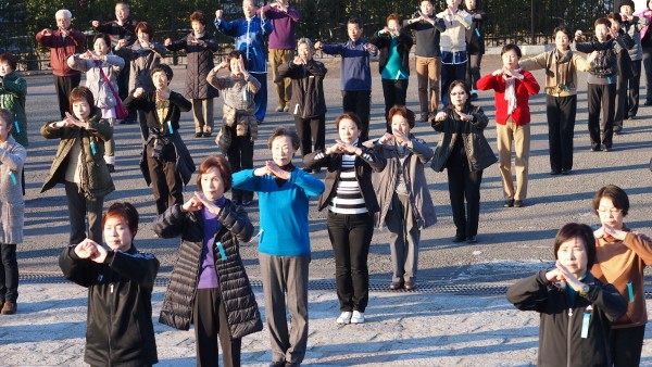 Groups of people practising taichi in front of Yoyogi Stadium at Harajuku, Tokyo, Japan